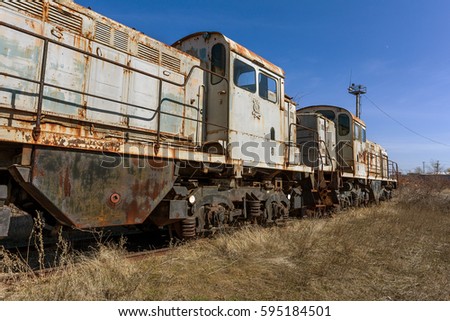 Old rusty train locomotive thrown Exclusion zone of Chernobyl. Zone of high radioactivity. Ghost town Pripyat. Chernobyl disaster. Rusty abandoned Soviet machinery in area of nuclear accident at plant