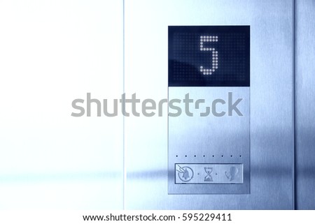 Floor number five on electronic LCD display in elevator of modern business center.