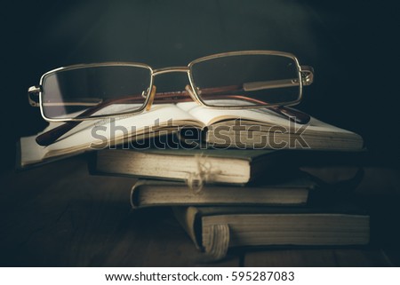 Books and glasses in the light