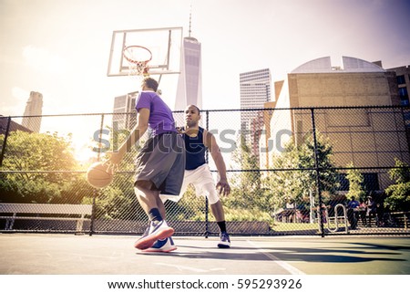 Two afroamerican athletes playing basketball outdoors - Basketball athlete training on court in New York
