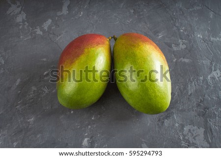 Tropical fruit mango on a gray background. Mango in the form of lungs.