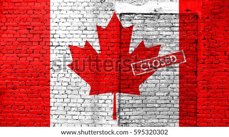 Canada flag on brick wall with bricked door and Closed sign