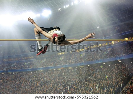 Athlete in action of high jump. Royalty-Free Stock Photo #595321562