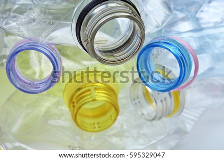 Close-up shot of stack of recyclable plastic bottles on white background in studio.