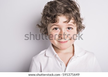 A kid portrait with curly hair on studio Royalty-Free Stock Photo #595375649