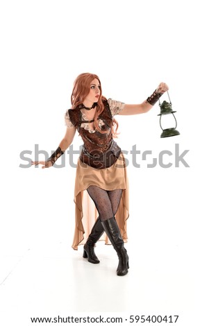 full length portrait of a beautiful girl wearing steampunk outfit, standing pose isolated on white background.