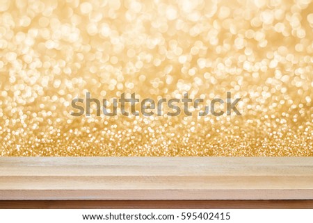 Brown wood floor scene of beautiful golden bokeh of gold blurred bokeh.Background with copy space for decorate design.