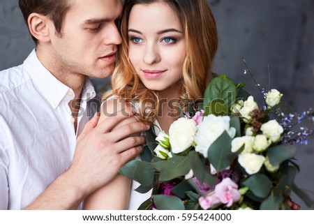 Beautiful young couple smiling and hugging