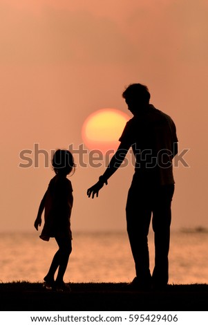silhouette happy family at sunset.