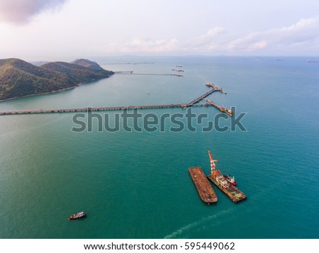 Aerial view of long concrete jetty head into the sea