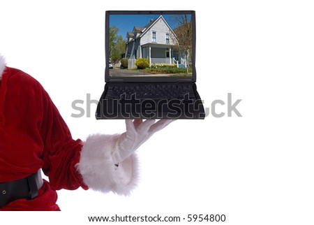 Santa Claus with laptop with a photo of a house on screen in his white gloved hand