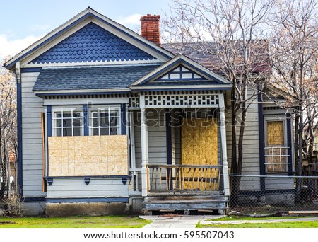 Old Boarded Up Home From Recession Royalty-Free Stock Photo #595507043