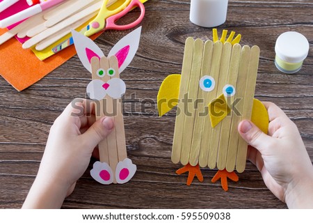 Children's easter gift from wooden chopsticks toy chicken and Easter bunny. Hand-made. The project of children's creativity, needlework, crafts for children. Royalty-Free Stock Photo #595509038