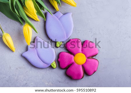 Spring background card cookies and flowers yellow tulips. Easter or Mother day holidays content. Top view with copy space