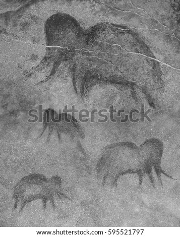 Drawing in a cave by an ancient Neanderthal man. Paint ocher. Group of mammoths. Cave man, wall, rock, primitive, prehistoric. Black and white