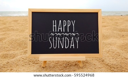 conceptual image with word HAPPY SUNDAY on Chalkboard at beautiful beach background.  