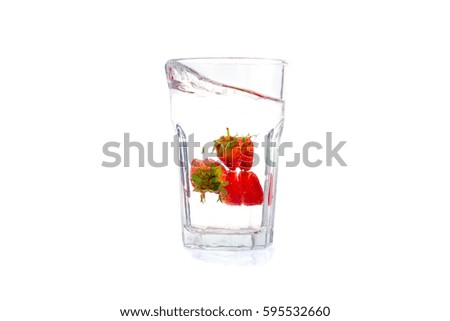 Water glass with floating strawberries, clipping path included