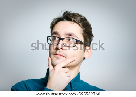 Business man thinking over solving a problem, isolated on a gray background