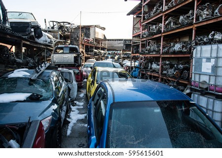 Recycling of old,used, wrecked cars. Dismantling for parts at scrap yards and sending for remelting.  Royalty-Free Stock Photo #595615601