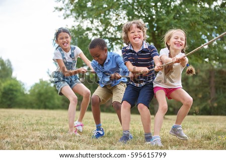 Interracial group of kids playing at the park Royalty-Free Stock Photo #595615799