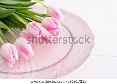 Closeup of pink tulips on pink plate