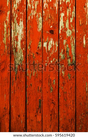 Texture of old wooden fence painted in orange