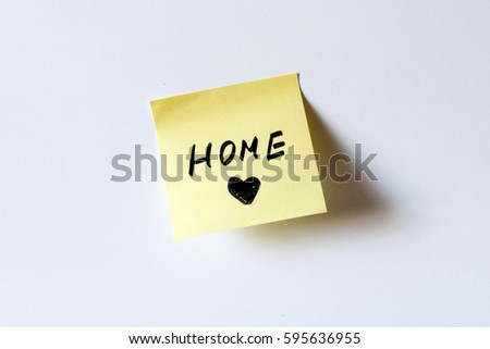 Yellow sticky note with text Home on white board. "Stay home", concept  against coronavirus.