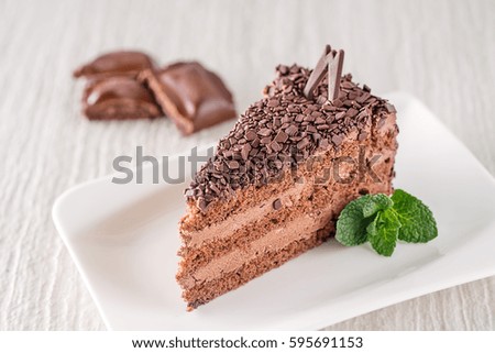 chocolate or coffee cream cake on white plate with mint leaf, gluten free cake, product photography for patisserie