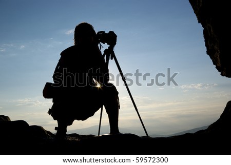 Silhouette of photographer in mountain. Element of design.