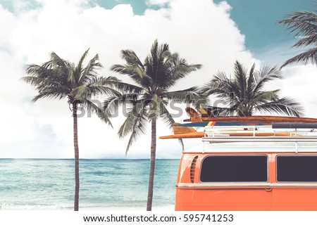 Vintage car parked on the tropical beach (seaside) with a surfboard on the roof - Leisure trip in the summer. retro color effect Royalty-Free Stock Photo #595741253
