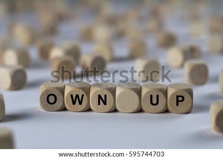 own up - cube with letters, sign with wooden cubes