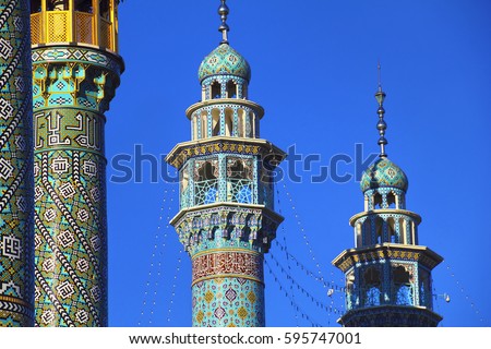 Beautiful view - minarets of Fatima Masumeh (Al-Masumah) Shrine and Masjid Azam Mosque at the background of bright blue sky in Qum (Qom) - the holy city for Shia Muslims, Iran, Middle East Royalty-Free Stock Photo #595747001