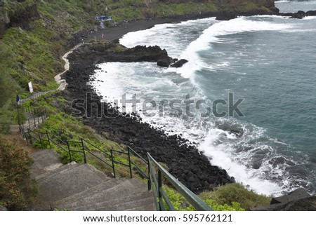 Winding path down to a beach with black lava sand and cliffs, picture from Puerto de la Cruz Tenerife Spain.