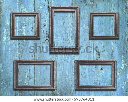 Old wooden frames on vintage blue wooden background