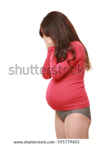 sad pregnant woman in studio shot on white background?