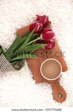 a mug of hot coffee stands on a wooden board. Breakfast in bed