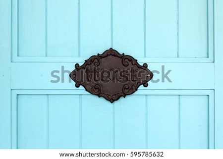 vintage welcome sign on blue wooden door