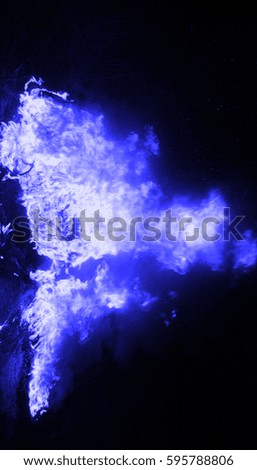 blue fire over a black background