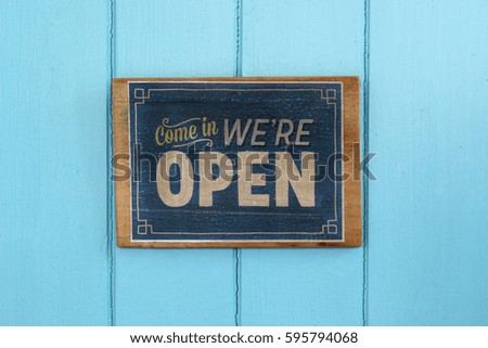 vintage open sign on blue wooden door
