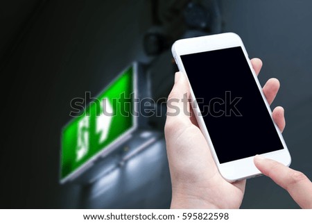 woman hand hold and touch screen smart phone,Emergency exit background