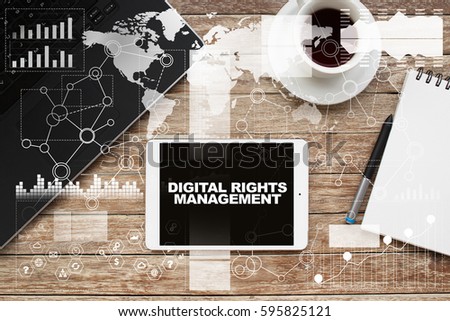 Tablet on desktop with digital rights management text.