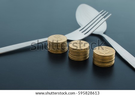 abstract fork and money on dark board business saving money concept.