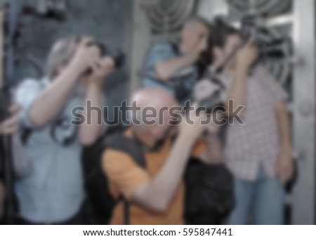 photographers are taking a picture blurred