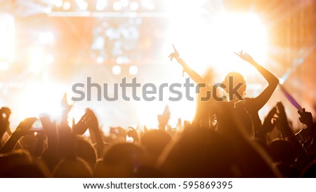 Crowd enjoying concert at festival dancing and partying