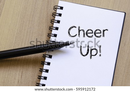Cheer up text concept write on notebook