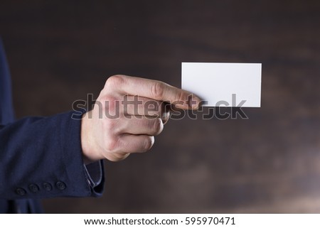 Businessman holding a blank business card