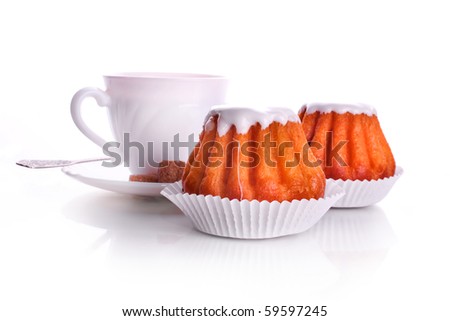 White cup of tea on a white background and a cake rum baba