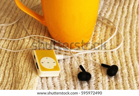 Yellow mug and mp3 player