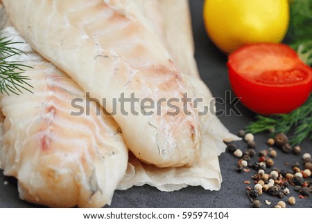 Raw fish fillet with spices, lemon and vegetables.