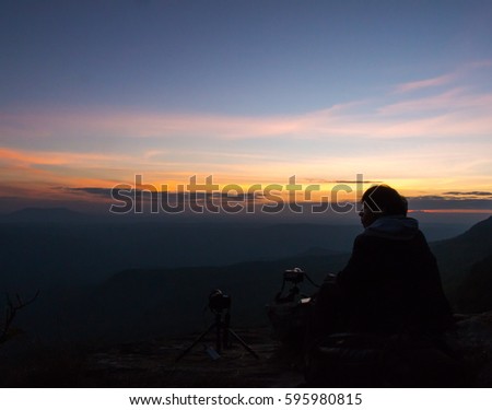 People sit picture sunset on the mountains.